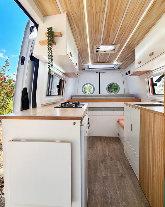 Área de armazenamento da Sprinter 416 Extra Longa, com armários e gavetas embutidos, em tons claros e design moderno